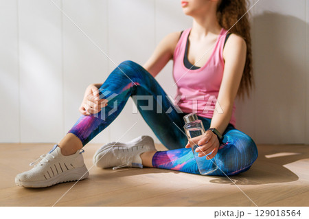 Woman in fashionable sportswear is doing exercise. Woman in fashionable sportswear is doing exercise. 129018564