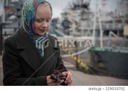 Close-up portrait of a young woman outdoors in cold day 129018702