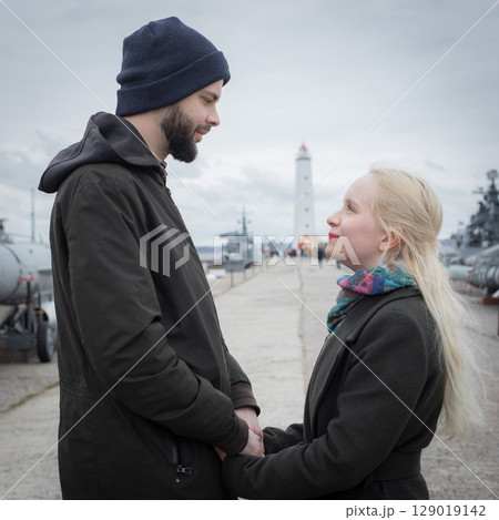 Affectionate young woman with blond hair and handsome man outdoors. Happy couple 129019142