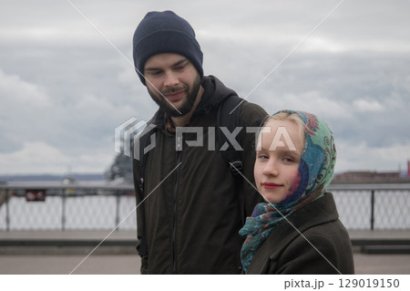 Young couple walking outside. Man and woman in love, outdoors lifestyle portrait 129019150