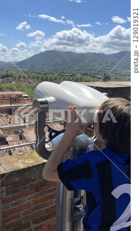 Child Viewing Scenic Landscape Through Binoculars 129019321