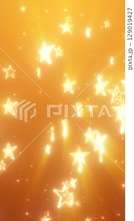 Floating glowing yellow stars scattered across a bright golden background with dreamy bokeh light effects 129019427