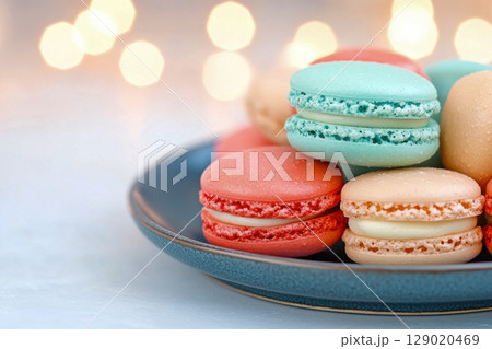Close-up view of vibrant red and teal macarons arranged on a decorative plate with a blurred background Close-up view of vibrant red and teal macarons arranged on a decorative plate with a blurred background 129020469