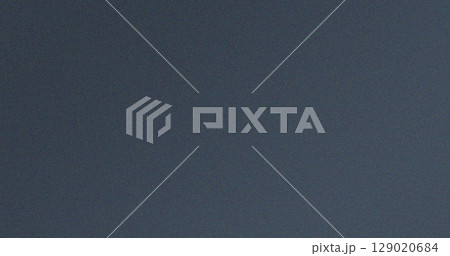 Grainy dark grey textured background with subtle noise effect 129020684
