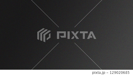 Gradient black and dark gray textured background with subtle grainy effect 129020685