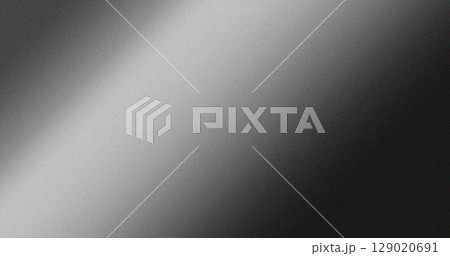 Monochrome grainy gradient background with black and grey shades blending smoothly. Minimalistic noise texture for design projects 129020691