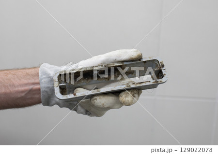 Bathroom drain with mildew and dirt in plumber hand Bathroom drain with mildew and dirt in plumber hand 129022078