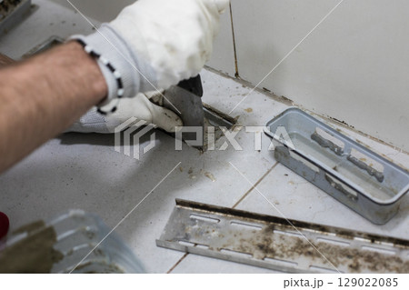Repairman repairs sewer and bathroom drain 129022085