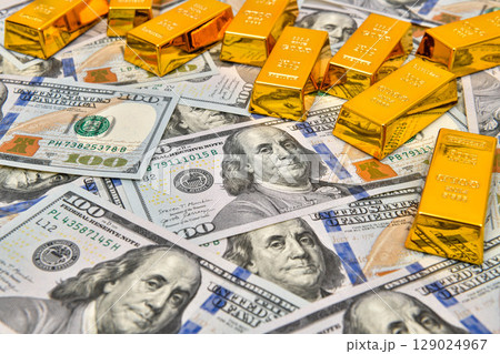 Paper us 100 dollar bill with gold bars, concept of investment and saving, wealth 129024967