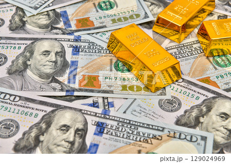 Paper us 100 dollar bill with gold bars, concept of investment and saving, wealth 129024969