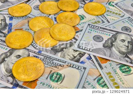 Bitcoin coins Crypto currency and paper money100 US dollar bills , virtual currency. Finance and investment concept. 129024971