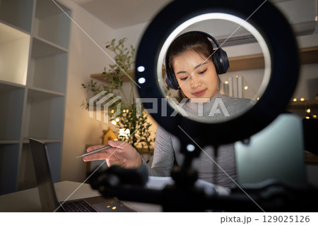 Podcast recording with a woman focused on her script 129025126