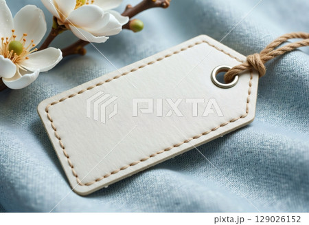 Blank tag on blue fabric with string Blank tag on blue fabric with string 129026152