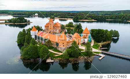 Aerial view of a castle on a small island in a lake 129027460
