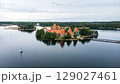 Aerial view of a castle on a small island in a lake 129027461
