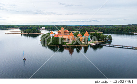 Aerial view of a castle on a small island in a lake 129027461