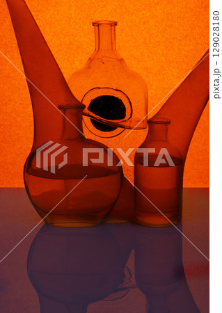 Still life with glassware with liquid and reflection 129028180