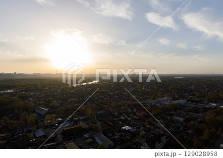Captivating Aerial View of a Cityscape Bathed in Golden Sunset Light, Showcasing the Harmony of Urban Life and Nature at Dusk Captivating Aerial View of a Cityscape Bathed in Golden Sunset Light, Showcasing the Harmony of Urban Life and Nature at Dusk 129028958