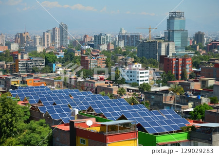Rows of solar panels are installed on rooftops, transforming sunlight into electricity in a densely populated urban setting 129029283