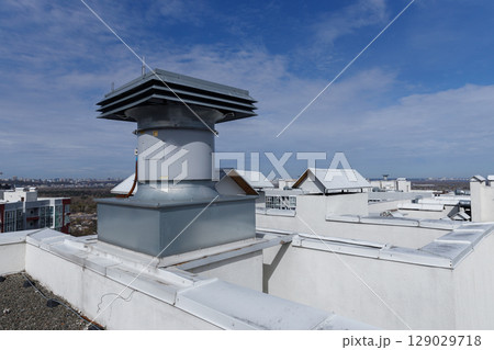 Top View of a Modern Rooftop Ventilation System Surrounded by Urban Architecture Under Clear Blue Skies - Architectural Details of a High-Rise Building Rooftop Top View of a Modern Rooftop Ventilation System Surrounded by Urban Architecture Under Clear Blue Skies - Architectural Details of a High-Rise Building Rooftop 129029718