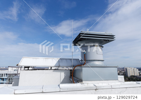 Overview of Rooftop Ventilation System with Clear Sky and Cityscape in the Background, Emphasizing Modern Architecture and Urban Infrastructure Overview of Rooftop Ventilation System with Clear Sky and Cityscape in the Background, Emphasizing Modern Architecture and Urban Infrastructure 129029724