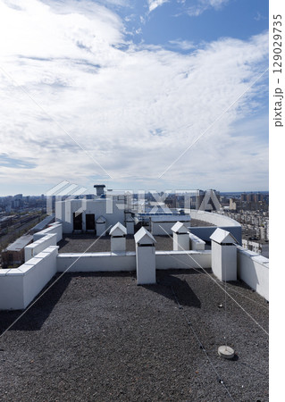 Stunning View from Rooftop: A Wide Angle Urban Landscape Underneath Beautiful Cloudy Sky Over Cityscape and Buildings Captured in Daylight 129029735