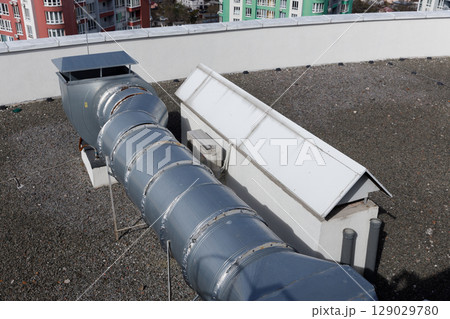 Overview of Rooftop Air Duct System Surrounded by Urban Apartment Buildings Highlighting Industrial Design Elements and Structural Features Overview of Rooftop Air Duct System Surrounded by Urban Apartment Buildings Highlighting Industrial Design Elements and Structural Features 129029780