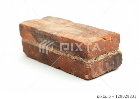 Old, weathered brick with cement on white background. Vintage, rustic look perfect for architecture projects. Close up detail offers copy space 129029833