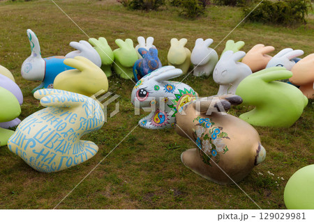 Colorful Sculptures of Rabbits Gathered in a Park, Adorned with Unique Patterns and Designs, Forming an Enchanting Artistic Display for All Visitors to Enjoy and Admire 129029981