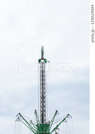 Exciting View of a Tall Amusement Park Ride Against a Cloudy Sky, Showcasing the Thrilling Design and Colors of the Giant Attraction for Adventure Seekers Exciting View of a Tall Amusement Park Ride Against a Cloudy Sky, Showcasing the Thrilling Design and Colors of the Giant Attraction for Adventure Seekers 129029984