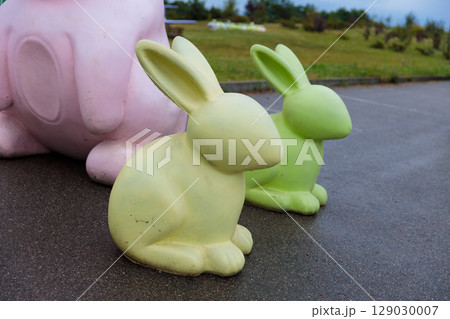 Adorable Colorful Rabbit Sculptures in a Park Setting, Showcasing Playful Designs with Pink and Green Hues That Brighten Up the Outdoor Environment and Capture Attention Adorable Colorful Rabbit Sculptures in a Park Setting, Showcasing Playful Designs with Pink and Green Hues That Brighten Up the Outdoor Environment and Capture Attention 129030007