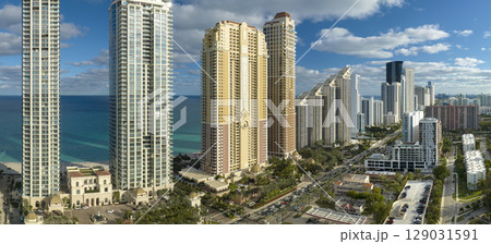 View from above of luxurious highrise hotels and condos on Atlantic ocean shore in Sunny Isles Beach city. American tourism infrastructure in southern Florida View from above of luxurious highrise hotels and condos on Atlantic ocean shore in Sunny Isles Beach city. American tourism infrastructure in southern Florida 129031591