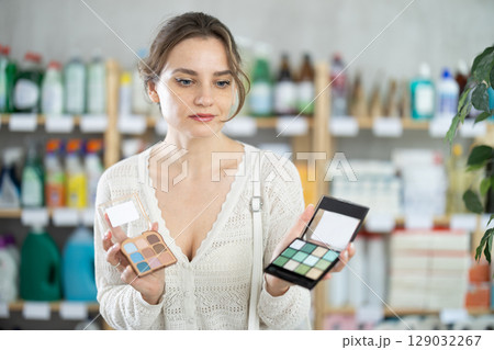 Young woman choosing cosmetics in supermarket Young woman choosing cosmetics in supermarket 129032267