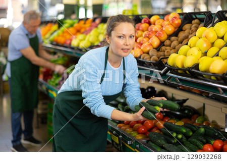 woman seller offers to buy cucumbers woman seller offers to buy cucumbers 129032268