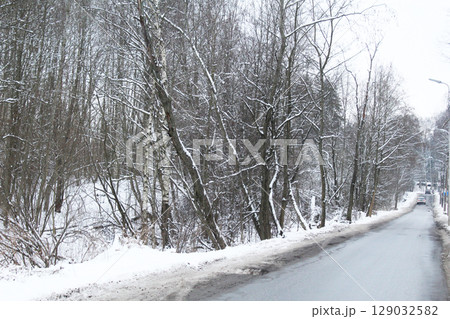 Trees grow along the road in winter. Winter Road. 129032582