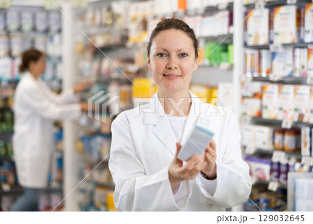 Female pharmacist offers various body care medicines 129032645
