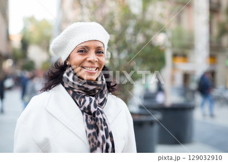 Portrait of a smiling woman on the street Portrait of a smiling woman on the street 129032910