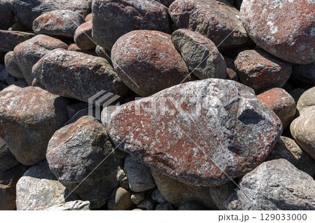 Close-Up View of Rough Textured Rocks in Natural Sunlight Outdoors 129033000