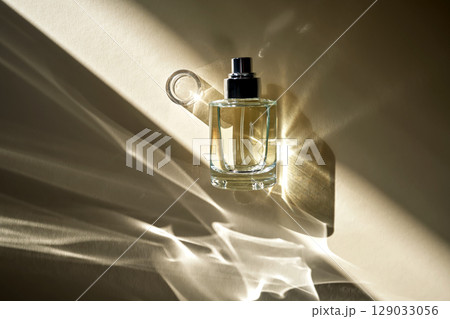 Perfume in the rays of bright sun with beautiful highlights. Perfume in the rays of bright sun with beautiful highlights. 129033056