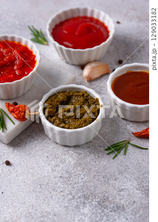 Set of different sauces. Ketchup, mustard, pesto Set of different sauces. Ketchup, mustard, pesto 129033182