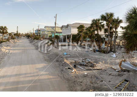 Trash from severely damaged houses after hurricane Milton storm surge. Piles of debris on street side on Manasota key street in Florida. Consequences of natural disaster Trash from severely damaged houses after hurricane Milton storm surge. Piles of debris on street side on Manasota key street in Florida. Consequences of natural disaster 129033222