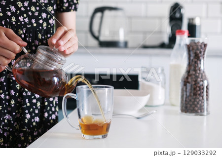 Little Girl Making A Black Tea Little Girl Making A Black Tea 129033292