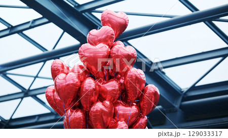 Tied Red Heart-Shaped Balloons 129033317