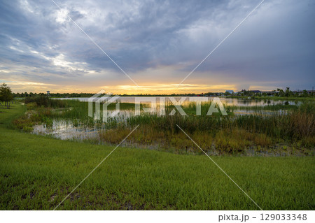 Sunset landscape in Wellen park in North Port, Florida. Beautiful lake nature in evening Sunset landscape in Wellen park in North Port, Florida. Beautiful lake nature in evening 129033348
