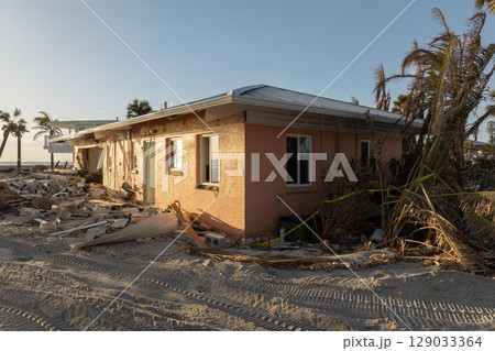 Storm surge caused by hurricane wind severe damaged residential houses on ocean shore. Natural disaster consequences in Florida 129033364