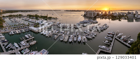 Sarasota, Florida at sunset. USA travel destination. Yachts docked in Sarasota Bay marina. American waterfront city downtown architecture Sarasota, Florida at sunset. USA travel destination. Yachts docked in Sarasota Bay marina. American waterfront city downtown architecture 129033401
