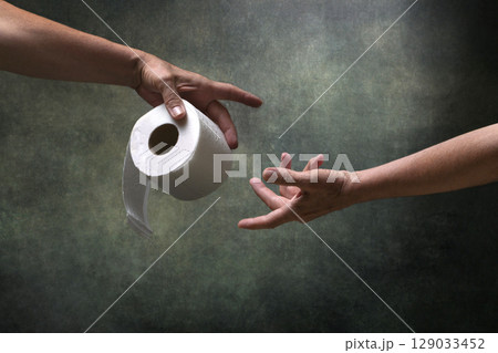 Two male hands with a roll of toilet paper. Help. Two male hands with a roll of toilet paper. Help. 129033452