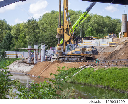 Heavy machinery used to dig a holes in a soil for bridge supports 129033999