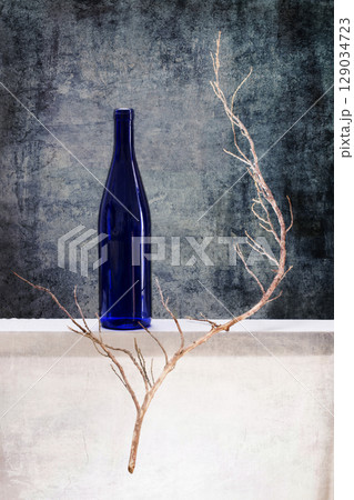 Still life with a blue bottle and a dry branch 129034723