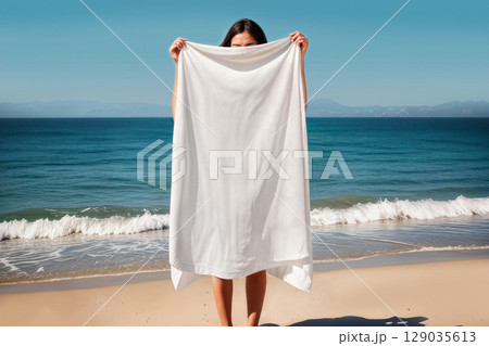 Blank white towel mockup on woman near sea, ai generated 129035613